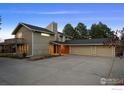 Two-story home with three-car garage and stone accents provides ample parking at 6668 Walker Ct, Niwot, CO 80503