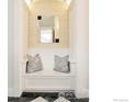 Cozy hallway nook with a built-in bench, decorative pillows, and a stylish mirror at 720 Mapleton Ave, Boulder, CO 80304