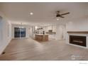 Open-concept living space featuring a modern fireplace, hardwood floors, and a stylish kitchen at 935 Eldorado Ln # A, Louisville, CO 80027