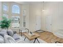 Cozy living room with large windows, lots of natural light, neutral walls, and hardwood floors at 1080 Stoneham St, Superior, CO 80027