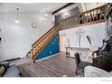 Inviting living room features hardwood floors, a staircase, and tasteful decor and accents at 11270 W 66Th Pl, Arvada, CO 80004
