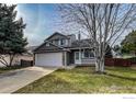 Charming two-story home featuring a two-car garage and covered front porch at 1219 Cedarwood Dr, Longmont, CO 80504