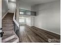 Open living room showcasing modern flooring and staircase leading to second floor at 1219 Cedarwood Dr, Longmont, CO 80504