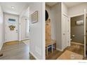 Well-lit entryway with a coat rack and bench, offering a welcoming and functional space at 14597 Shorthorn Dr, Mead, CO 80542