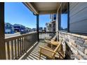 Inviting front porch with chairs, perfect for relaxing and enjoying the neighborhood views at 14597 Shorthorn Dr, Mead, CO 80542