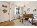 Cozy living room with abundant natural light, stylish furnishings, and elegant decor at 14597 Shorthorn Dr, Mead, CO 80542