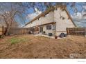 Spacious backyard with wood fence, small patio, and mature landscaping at 1561 S Sheridan Blvd, Lakewood, CO 80232
