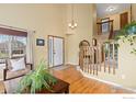 Bright foyer with hardwood floors, high ceilings, and staircase leading to the upper level at 1898 Wilson Cir, Erie, CO 80516