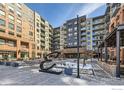 Condominium exterior showcasing courtyard, modern architecture, and public art installation near entry at 20 Wilcox St # 518, Castle Rock, CO 80104