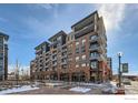 Exterior of modern condominium building with stylish balconies, retail space, and landscaped grounds at 20 Wilcox St # 518, Castle Rock, CO 80104