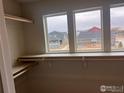 Walk-in closet with shelves, rods and a window at 2261 Peregrine Dr, Brighton, CO 80601