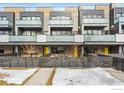 Modern townhouse exterior featuring balconies and contemporary design with a partial snow-covered yard at 2471 Walnut St, Boulder, CO 80302