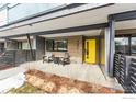 Inviting front porch with a vibrant yellow door and seating area, offering curb appeal at 2471 Walnut St, Boulder, CO 80302
