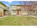 Charming townhome with a well-manicured front yard and inviting red front door at 3264 Cripple Creek Trl, Boulder, CO 80305