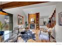 Bright living room with wood floors, fireplace and views at 3264 Cripple Creek Trl, Boulder, CO 80305