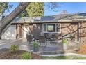 Close-up of a brick home with an outdoor patio, seating, and manicured landscaping at 3282 4Th St, Boulder, CO 80304