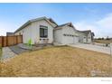Attractive home with a well-maintained lawn and fenced yard, displaying a welcoming curb appeal at 334 Rhubarb Dr, Berthoud, CO 80513
