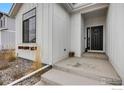 Inviting entryway showcasing a black front door, window box, and decorative details at 334 Rhubarb Dr, Berthoud, CO 80513