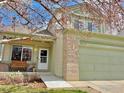 Charming two-story home with a well-manicured lawn and a inviting front porch at 3469 Larkspur Dr, Longmont, CO 80503
