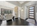 Elegant living room with stone fireplace, dark hardwood floors, and ample natural light at 350 15Th St, Boulder, CO 80302