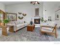 Bright living room features a vaulted ceiling, fireplace, and large windows at 3885 Birchwood Dr, Boulder, CO 80304