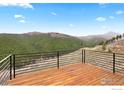 Outdoor wooden deck with mountain views at 450 Melvina Hill Rd, Boulder, CO 80302