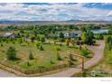 Expansive aerial view showcasing the beautiful property, lake, and surrounding landscape with mountain views at 4514 Hoot Owl Dr, Berthoud, CO 80513
