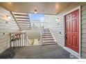 Exterior entrance to a condo with stairs and a red door at 4945 Twin Lakes Rd # 39, Boulder, CO 80301