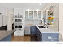 A view of the kitchen area featuring stainless steel appliances and modern fixtures at 501 W Linden St, Louisville, CO 80027