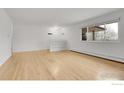 Spacious living room with hardwood floors, built in bookshelves, and large windows at 615 S Shoshone St, Denver, CO 80223
