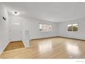 Bright living room featuring hardwood floors and lots of natural light from large windows at 615 S Shoshone St, Denver, CO 80223