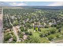 Aerial view of a home in a lush, green neighborhood, near a golf course and park at 6916 Hunter Pl, Boulder, CO 80301
