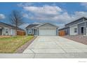 Charming single-Gathering home featuring a well-kept lawn and a wide two-car garage at 702 S Fulton Ave, Fort Lupton, CO 80621