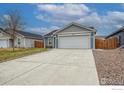 Charming single-Gathering home with a two-car garage and concrete driveway at 702 S Fulton Ave, Fort Lupton, CO 80621