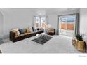 Bright living room featuring modern design, comfortable sofa, rug and natural light at 702 S Fulton Ave, Fort Lupton, CO 80621
