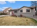 Attractive home featuring a red front door, a well-kept lawn, and a combination of brick and siding at 9331 Irving St, Westminster, CO 80031