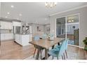 Open concept featuring a dining area adjacent to the kitchen, with a table, chairs, and sliding door access at 9968 E Kansas Ave, Aurora, CO 80247