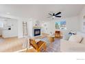 The light-filled living room boasts wood floors, fireplace and picture window views at 1210 Baker St, Longmont, CO 80501