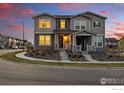 Charming two-story home featuring a well-maintained lawn, inviting entrance, and modern architectural details at 1365 Shale Dr, Erie, CO 80516