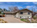 Charming two-story home with front porch including white Adirondack chairs and driveway at 1525 Judson Dr, Boulder, CO 80305