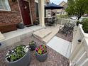 Charming front porch with seating, potted plants, and a stylish entrance, enhancing curb appeal at 16022 W 63Rd Ln # A, Arvada, CO 80403