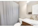 Bathroom features a shower with a gray curtain, modern vanity, and decorative light fixture at 1607 Cottonwood Dr # 14, Louisville, CO 80027