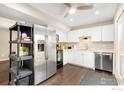 Modern kitchen with stainless steel appliances, white cabinetry, and ample countertop space for meal preparation at 1607 Cottonwood Dr # 14, Louisville, CO 80027