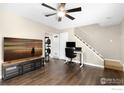 Bright living room features wood floors, ceiling fan, and nearby access to the stairway and entryway at 1607 Cottonwood Dr # 14, Louisville, CO 80027