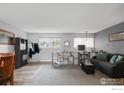 Bright living room with stylish gray walls, modern furniture and a large window providing natural light at 1622 Quivira Dr, Denver, CO 80229