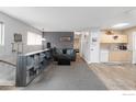 Comfortable living room with ample storage, a modern sofa, and an open layout to the kitchen at 1622 Quivira Dr, Denver, CO 80229