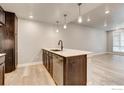 New kitchen boasts stainless dishwasher, modern countertops, and sleek dark cabinets at 235 High Point Dr # 102, Longmont, CO 80504