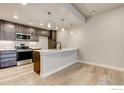 Bright, open kitchen with stainless steel appliances and modern countertops at 235 High Point Dr # 102, Longmont, CO 80504