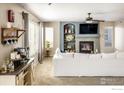 Bright living room featuring a fireplace, modern décor, and natural light from large windows at 2353 Aral Dr, Longmont, CO 80504