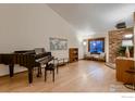 Open-concept living area featuring hardwood floors, a piano, and ample natural light at 2614 Denver Ave, Longmont, CO 80503